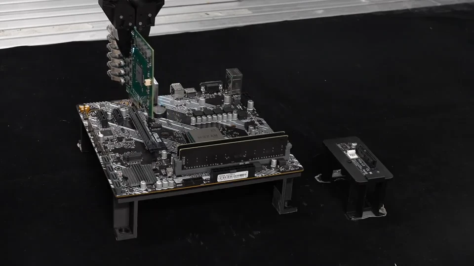 Robot aligning an expansion card with a motherboard slot